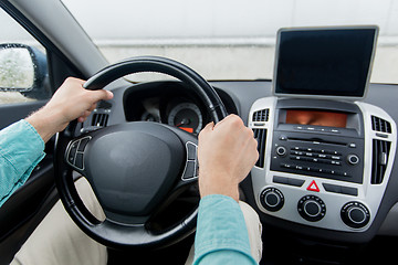 Image showing close up of young man with tablet pc driving car