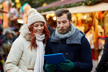 Image showing happy couple walking with tablet pc in old town