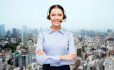 Image showing helpline operator in headset over city background