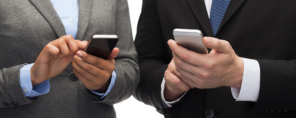 Image showing businessman and businesswoman with smartphones