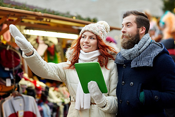 Image showing happy couple walking with tablet pc in old town