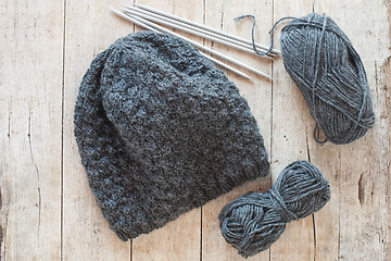 Image showing wool grey hat, knitting needles and yarn