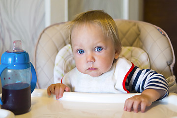 Image showing Small baby with bib at the table