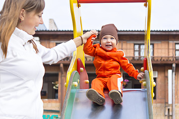 Image showing Small boy with a smile on children's slide