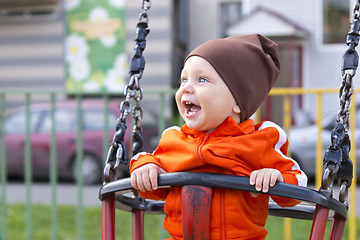 Image showing Joyful toddler on a swing