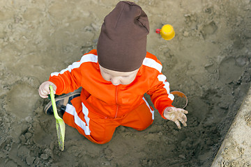 Image showing Baby is playing in sandbox