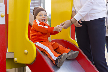 Image showing Kid with a smile on children's slide