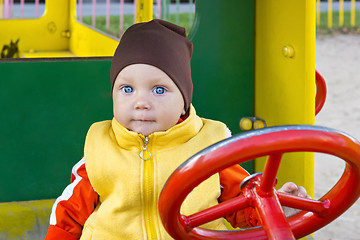 Image showing One year old boy at the wheel