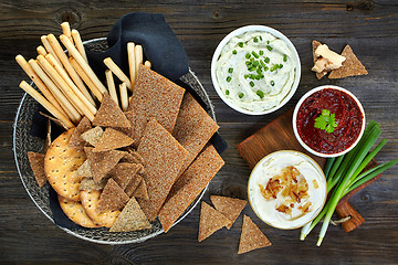 Image showing various dip sauces and bowl of bread cookies