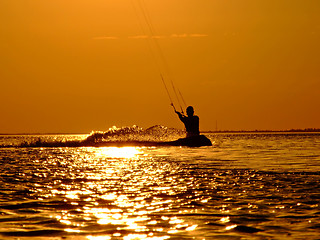 Image showing Silhouette of a kite-surf on waves of a gulf on a sunset 2