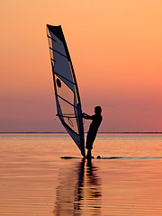 Image showing Silhouette of a wind-surfer on waves of a gulf on a sunset 3