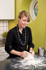 Image showing Woman Kneading Dough at Home