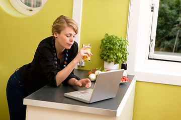 Image showing Using Laptop in Kitchen