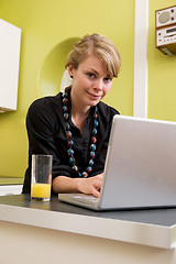 Image showing Woman Using Computer in Kitchen