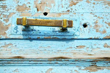Image showing rusty metal nail dirty stripped paint in the blue  
