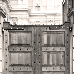 Image showing brown wooden parliament in london old  door and marble antique  