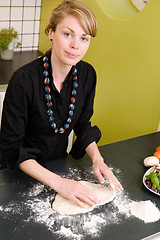 Image showing Young Woman Making Pizza Dough