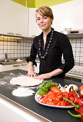 Image showing Young Woman Making Pizza Dough