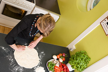 Image showing Young Woman Making Pizza Dough