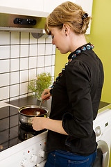 Image showing Female Cooking Supper in Kitchen