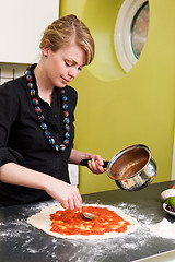 Image showing Young Woman Making Pizza