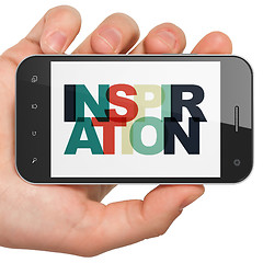 Image showing Marketing concept: Hand Holding Smartphone with Inspiration on  display