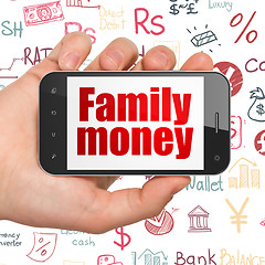 Image showing Banking concept: Hand Holding Smartphone with Family Money on display