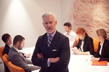 Image showing senior business man with his team at office