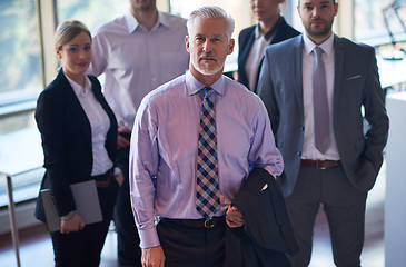 Image showing senior business man with his team at office