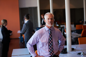 Image showing senior business man with his team at office