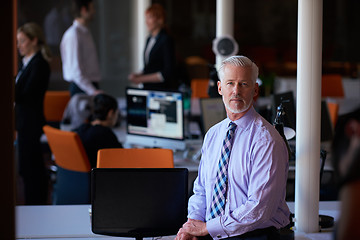 Image showing senior business man with his team at office