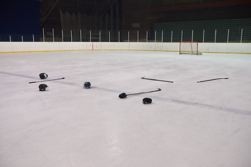 Image showing hockey sticsk and puck on ice