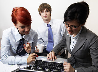 Image showing confident young manager at work with laptop