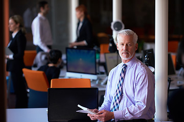 Image showing senior business man with his team at office