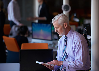 Image showing senior business man with his team at office