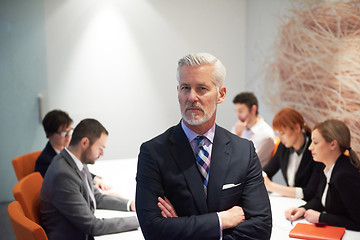 Image showing senior business man with his team at office