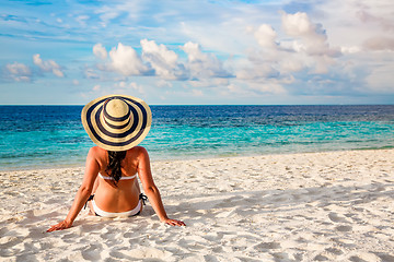 Image showing Girl walking along a tropical beach in the Maldives.