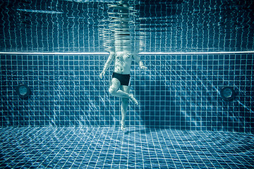 Image showing Persons standing under water in a swimming pool