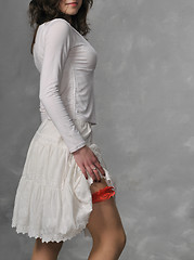 Image showing White dressed girl and red garter
