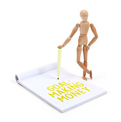 Image showing Wooden mannequin writing - Goal: Making money