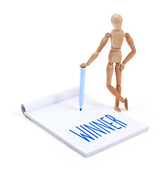 Image showing Wooden mannequin writing - Winner