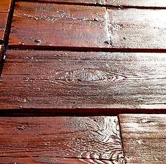 Image showing grain texture of a brown antique wooden old door in italy   euro