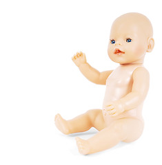 Image showing Little naked girl baby doll with blue eyes waving towards white