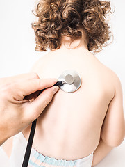 Image showing Child at pediatrician with health check using stethoscope on bac