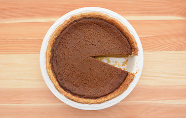 Image showing Pumpkin pie with one slice taken