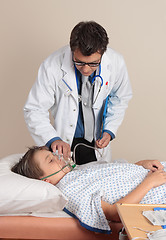 Image showing Doctor adjusting face mask