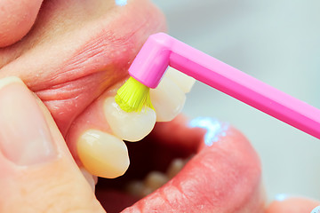 Image showing Dentist showing a woman how to brush her teeth