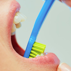 Image showing Dentist showing a woman how to brush her teeth