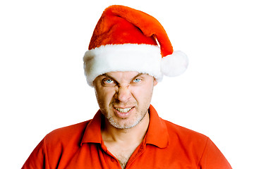 Image showing Unshaven angry man in a red shirt and Santa hats. Studio. isolat