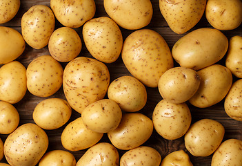 Image showing potatoes on wooden background